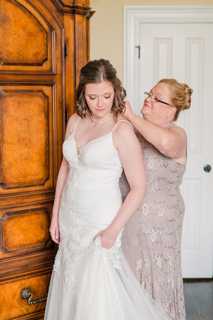 Tiffany's mom clasps a necklace around her neck.