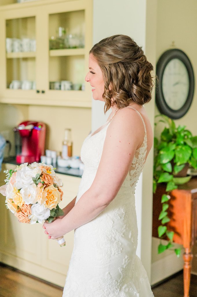 Tiffany smiles as her bridesmaids see her in her dress for the first time.